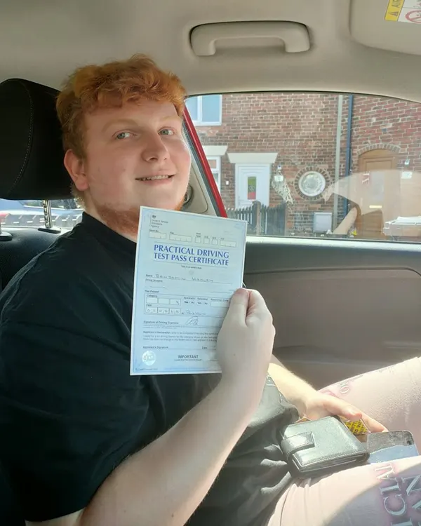 Learner celebrating a first-time driving test pass with Jamie Almond Driving Tuition