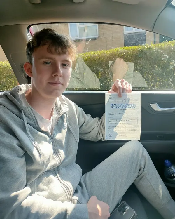 Happy learner with pass certificate after driving lessons in the Staffordshire Moorlands