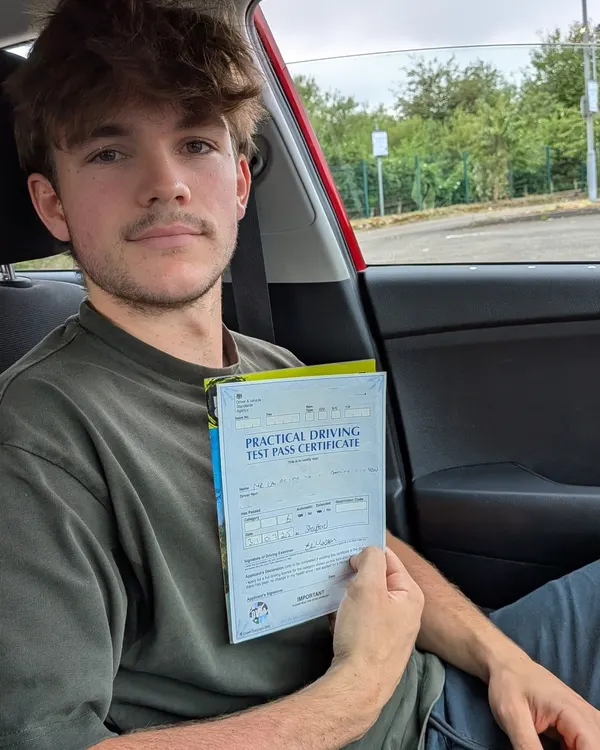 Learner holding driving test pass certificate, taught by Jamie Almond