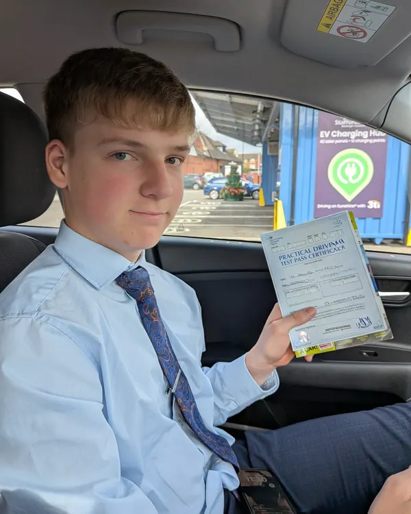 Learner driver celebrating their practical test pass