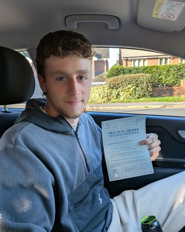 Driving test passed — happy learner with certificate